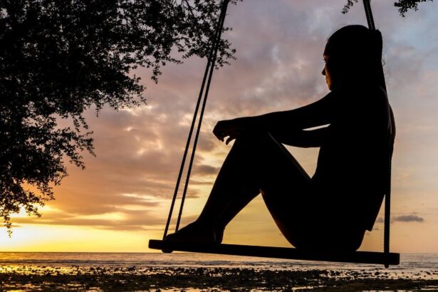 silhouette of girl on swing
