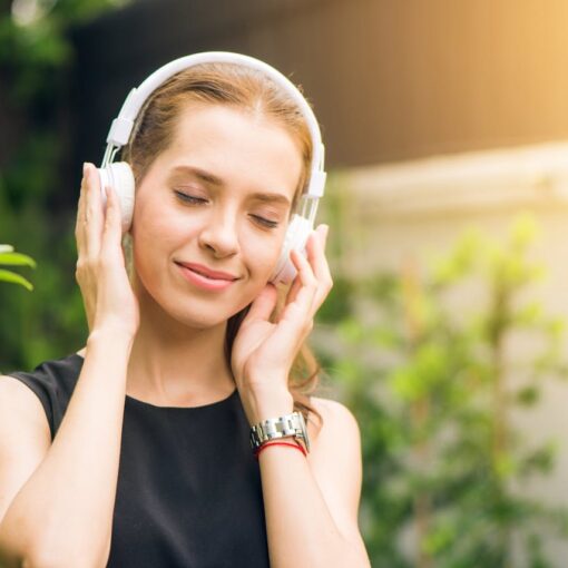 woman-in-nature-with-headphones-happy-and-peaceful