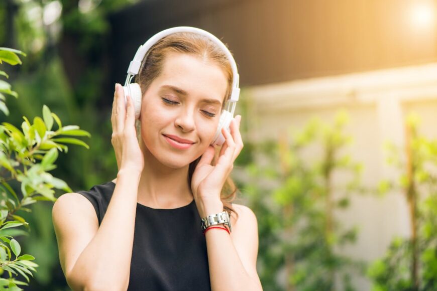 woman-in-nature-with-headphones-happy-and-peaceful